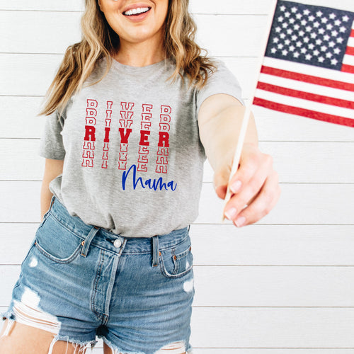 River Mama text in red and blue on grey tshirt with woman holding USA flag