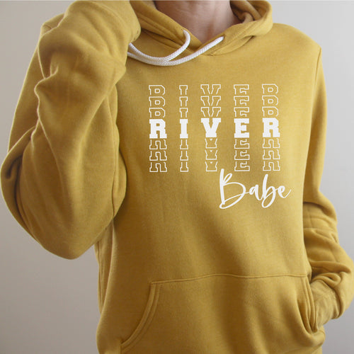 river babe in white on mustard hoodie